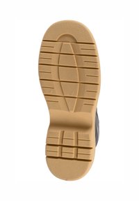 Suola in gomma con un motivo di presa testurizzato; colore beige chiaro con scanalature e rientranze, progettata per offre trazione e durata.