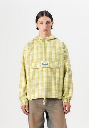 Green plaid hooded jacket with a front pouch pocket, adjustable drawstring hem, and a blue logo patch on the chest. Lightweight material.