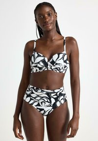 Sorte og hvide blomstrede bikini sæt med en polstret bralette-top med justerbare stropper og højtaljede rynkede bund. Glat stoftekstur.