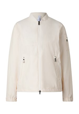 Béžová bomber bunda s předním zipem, dvěma zipy na bočních kapsách, zipem na kapse na rukávu a stojáčkovým límcem.