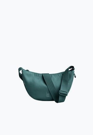 Sac bandoulière vert avec une sangle large réglable et une fermeture éclair, affichant un logo discret "GOT BAG" au centre avant.