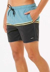 Shorts de bain bleu et noir avec des rayures jaunes, taille élastique, cordon de serrage réglable, poche latérale et patch logo Rip Curl sur l'ourlet.