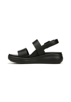 Black sandal featuring two wide straps, a cushioned sole, and a sleek, rounded shape for comfort and support. Textured leather accents add detail.