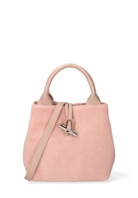 Sac en suédine de couleur rose pâle avec une fermeture à cordon, au design léger et à l'anse amovible. Présente des poignées texturées et arrondies.