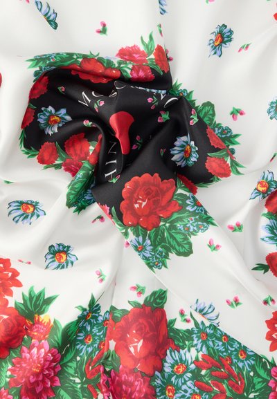 Floral silk fabric featuring white background with red roses and blue flowers, accented by green leaves and black section with text.