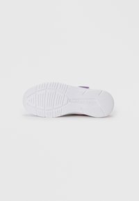White athletic shoe sole with textured grip pattern, featuring a raised logo in the midsole. Color accents in purple and orange visible.