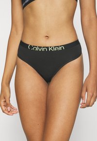 Calvin Klein Underwear MODERN THONG - String - black/sunny lime