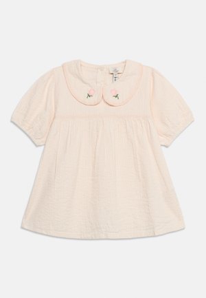 Light pink baby dress with short puff sleeves, textured fabric, rounded collar featuring small embroidered pink flowers with green stems.