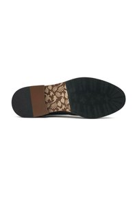 Shoe sole with black rubber bottom, dark brown accent, and an intricate floral pattern in gold on the midsole. Textured surface design.