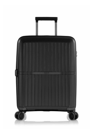 Black hardshell suitcase with ridged texture, retractable handle, and four wheels for mobility. Features a subtle brand logo on the front.