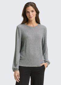Gray long-sleeve shirt with a geometric pattern, crew neckline, and elastic cuffs, paired with black pants. Soft, textured fabric.