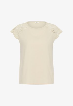 Blouse à manches courtes de couleur crème avec un col rond et des détails en dentelle sur les épaules et le haut des manches.