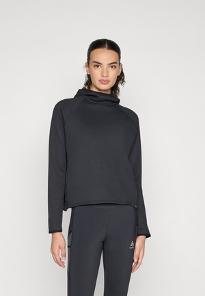 Black ribbed pullover with a high neck and long sleeves, featuring a loose fit and slight side slits at the hem, made from a textured fabric.