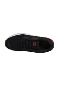 Black athletic shoe with mesh and synthetic upper, lace-up design, white midsole, and red accent logo, featuring sturdy rubber outsole.