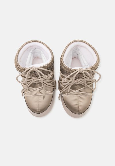 Tan padded ankle boots with round toe and contrasting white lining, featuring textured laces and light rubber soles for grip.