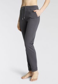 Graue Sweatpants mit einem Kordelzugbund, Seitentaschen und umgeschlagenen Säumen. Hergestellt aus einem weichen, glatten Stoff mit dezentem gesticktem Branding.