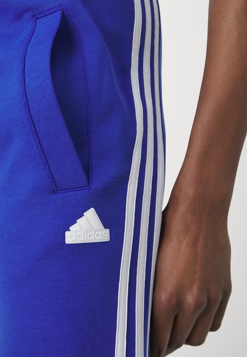 adidas tracksuit bottoms blue stripe