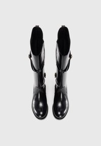 Pair of black shiny knee-high boots with side buckle straps, shown from above on a plain white background.