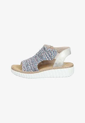 Open-toe women's sandal with multicolored woven upper, beige cushioned footbed, silver heel strap, and thick white ridged sole.