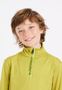 Groene rits-pullover gemaakt van rekbaar materiaal. Heeft een hoge kraag, logo-print langs de rits en een gladde textuur.