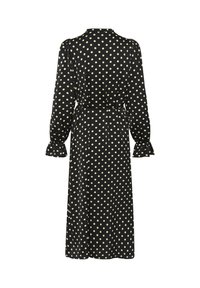 Schwarzes Kleid mit cremefarbenen Polka-Dots, langen Ärmeln, gerüschten Manschetten und betonter, gebundener Taille. Glatter Stoff, mittellanges Design.