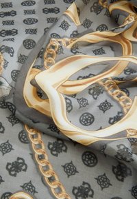 Silky gray scarf featuring gold chain and ornate patterns. The design includes black motifs and a smooth texture.