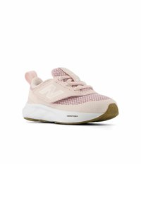Light pink athletic shoe with mesh upper, padded collar, and white logo. Features a rounded toe and a textured white and tan sole.