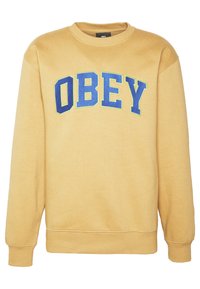 Yellow sweatshirt made of soft fabric, featuring "OBEY" in bold blue and green text across the chest. Classic crew neck and ribbed cuffs.