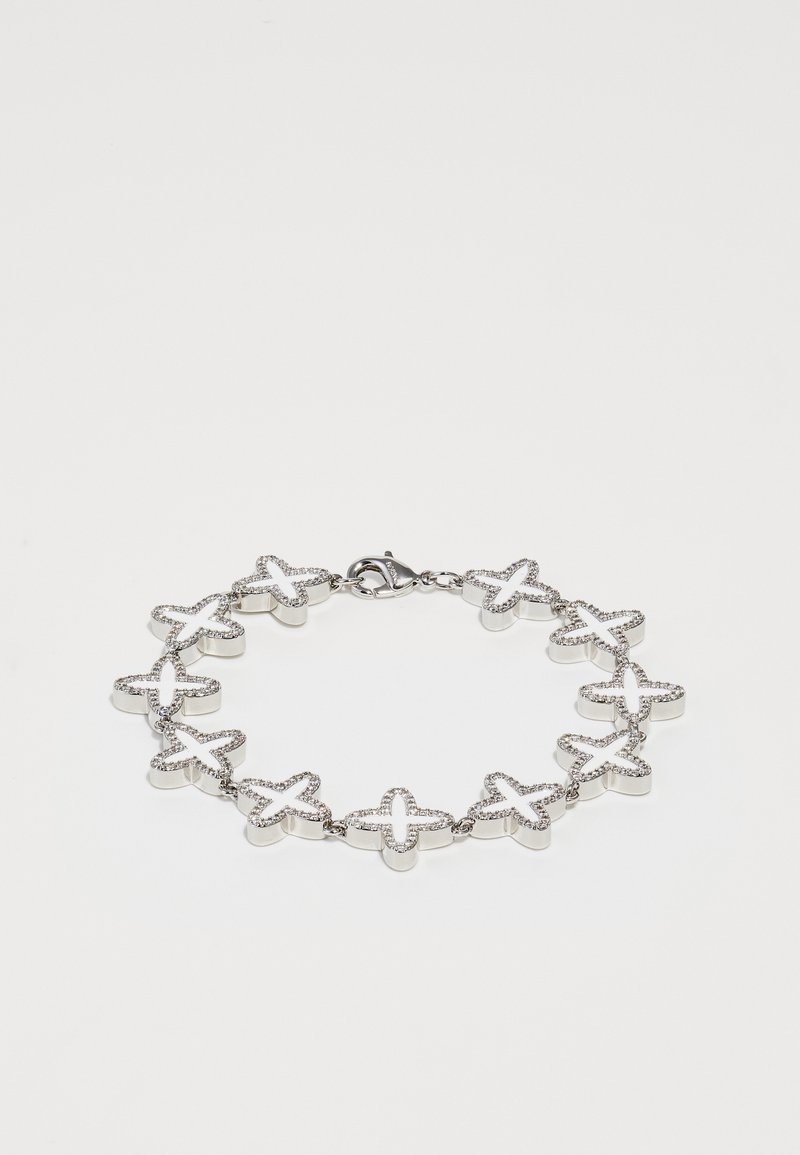 Hõbedane käevõru, millel on tähekujulised lingid tekstureeritud pindade ja selgete rhinestone aktsentidega. Sulgemine ühel küljel.