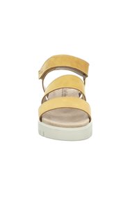 Yellow leather sandal with three wide straps and a hook-and-loop fastener. Features a padded footbed and a white rubber outsole.