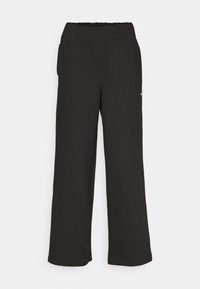Pantalones negros de pierna ancha hechos de una tela texturada con cinturilla elástica. Con bolsillos laterales y un pequeño detalle de logo.