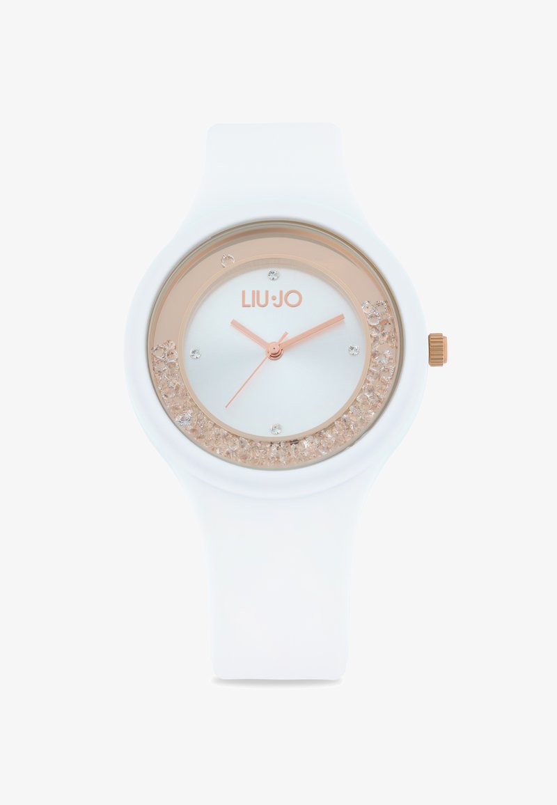 Hvid silikoneur med en rosaguld bezel, krystalbesat urskive og lyseblå ansigt, der viser sølvfarvede visere og et logo.