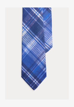 Sinisruudullinen kauluspanta, jossa on valkoisia ja tummansinisiä leikkaavia viivoja vaalealla pohjalla.