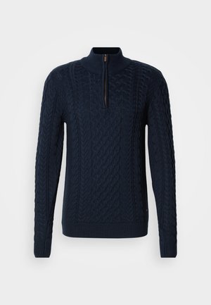 Navy knitted sweater with a high collar, featuring a quarter zip, textured cable patterns, and ribbed cuffs and hem.