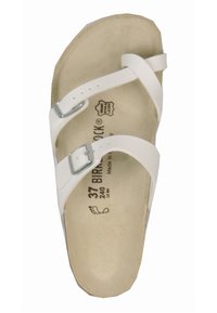Sandal bianca con due cinturini regolabili, fibbie argentate e una soletta sagomata. Realizzata in materiale sintetico con una consistenza liscia.