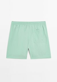 Costumi da bagno verde menta con cinturino elastico, tasca posteriore singola e tessuto leggero. Presentano una vestibilità rilassata e svasata.