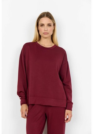 Burgundy sweatshirt with long sleeves, round neckline, and ribbed cuffs. Soft fabric and relaxed fit, paired with matching bottoms.