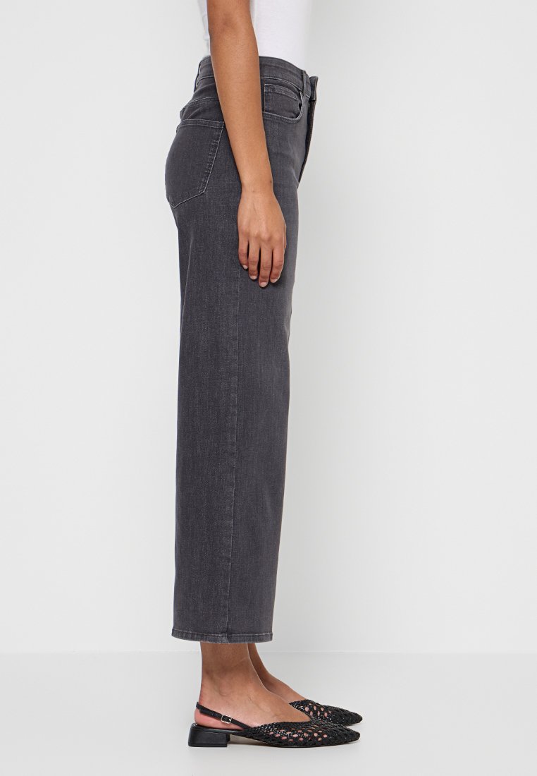 Jeans a vita alta, a gamba dritta, in denim grigio scuro. Caratterizzati da tasche classiche e una texture liscia. Abbinati a scarpe nere senza lacci.