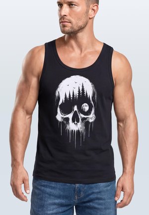Muscular man wearing a black tank top with a white skull graphic showing pine trees, birds, and a full moon inside the skull.