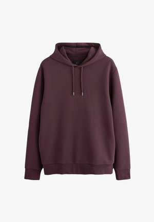 Burgundy kapuutsiga pusa, millel on tekstureeritud mesilätsede muster. Varustatud reguleeritava kapuutsiga ja soonikkoes mansettide ja hemiga. Sile kangas.