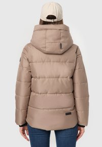 Puffer jacket in light beige, with a hood and stitched sections, featuring a black logo patch on the lower back and a smooth texture.