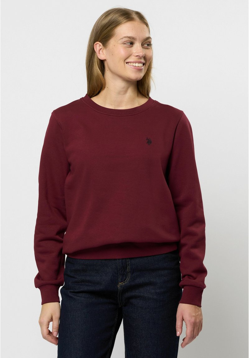 Felpa bordeaux realizzata in morbido cotone, con scollatura rotonda, polsini a coste e un piccolo logo sul petto.