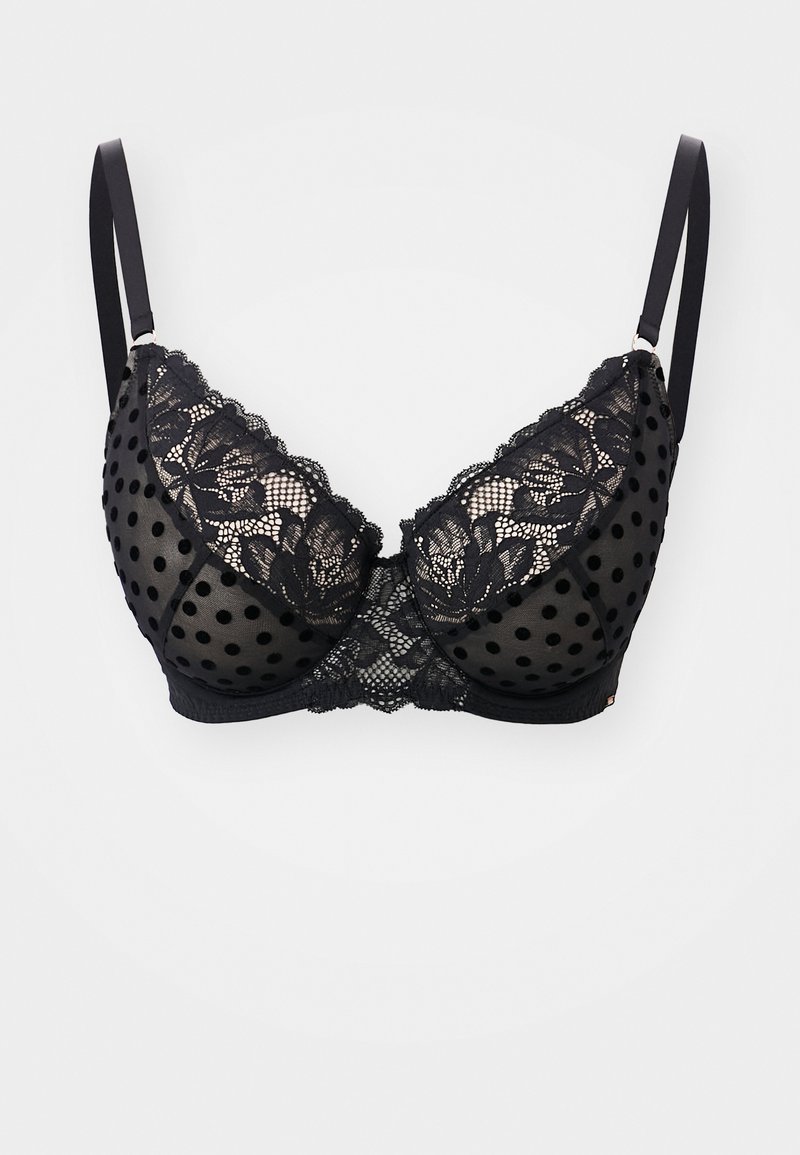 Must mustrõngaga rinnahoidja, millel on täpikate võrgust ja lillemustriga pits, reguleeritavate õlapaeltega ja tekstuurse pinnaga.