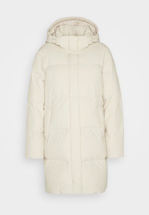 Krämfärgad pufferjacka med huva, med en kviltad design och rak skärning. Tillverkad av mjukt, lätt material.