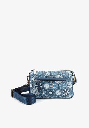 Blue patterned crossbody bag with geometric designs, front zipper pocket, and adjustable wide navy strap with gold-tone hardware.