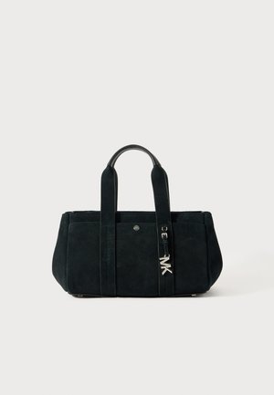 Black suede tote bag with two short handles, featuring a silver logo accent and minimalistic design. Smooth texture, rectangular shape.