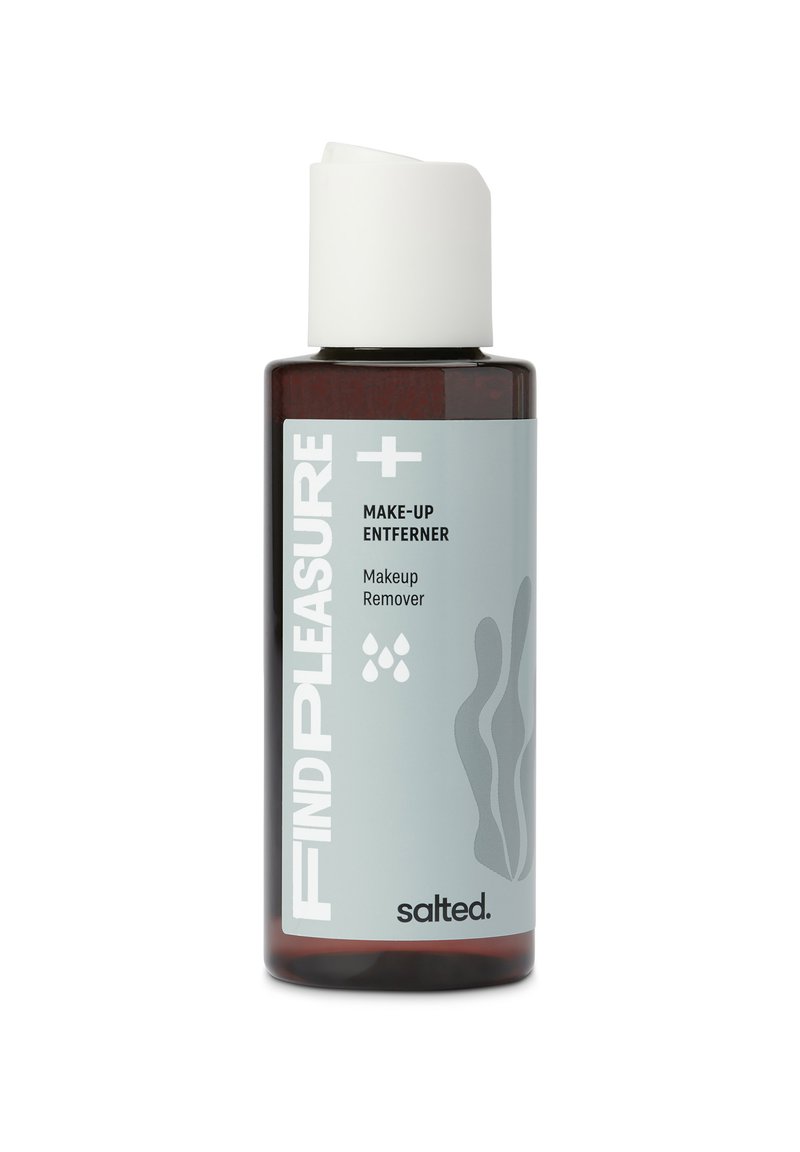 Bruine glazen fles met witte schroefdop; gelabeld "VIND PLEZIER + MAKE-UP VERBETERAAR," bevat make-up remover; lichtgrijze accenten en golvend patroon.