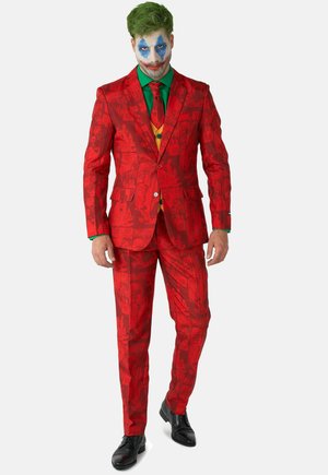 Red suit with comic-style print featuring faces and "HA HA" text. Includes a green shirt and tie, with black shoes and vibrant face paint.