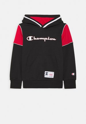 Czarna i czerwona bluza Champion z kapturem, z białym logo na piersi, przednią kieszenią typu kangurka oraz metką USA przy dolnym brzegu, rozłożona na płasko na białym tle.