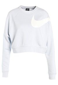 Ljusblå kort sweatshirt gjord av mjukt material. Har en stor vit Nike-logotyp på framsidan och ribbade ärmslut. Rund halsringning.